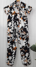Relax in style with this handmade rayon cotton black and white abstract floral pajama set for women, featuring a comfortable fit and convenient pockets.