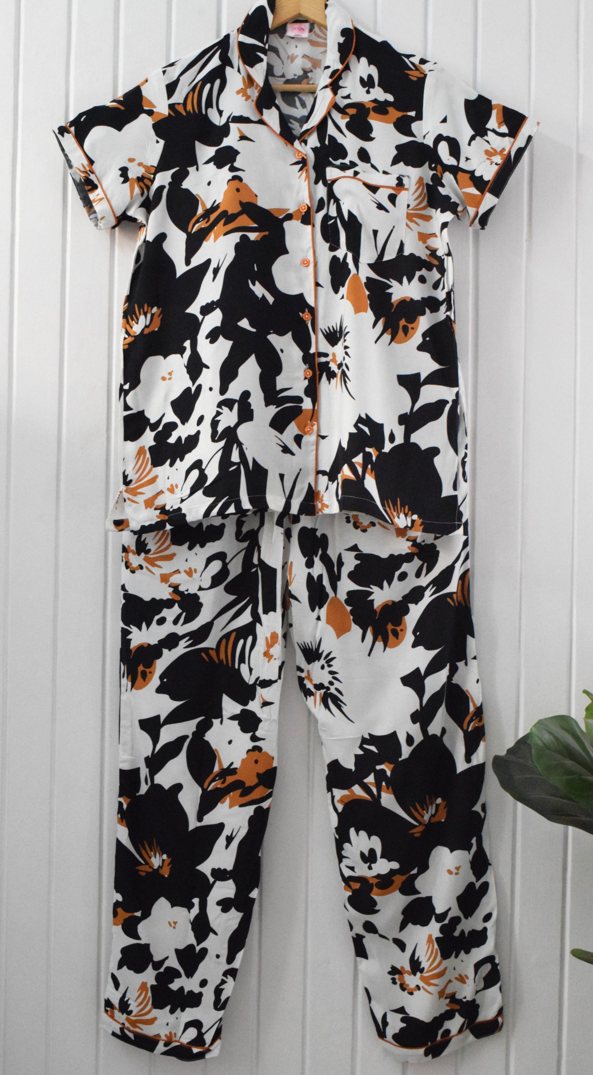 Relax in style with this handmade rayon cotton black and white abstract floral pajama set for women, featuring a comfortable fit and convenient pockets.